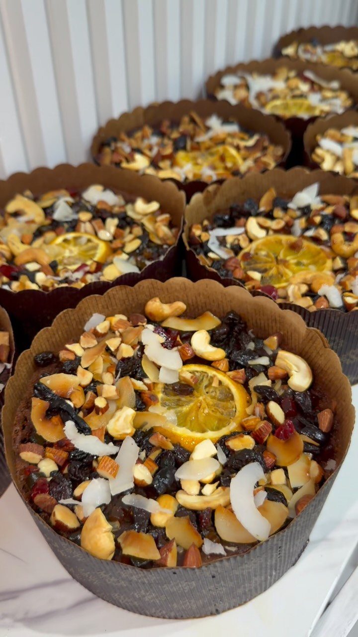 12 Beautiful Christmas Cake Ideas That Rival Bakery Work 7 Small round cakes topped with dried fruits, nuts, coconut flakes, and candied orange slices.