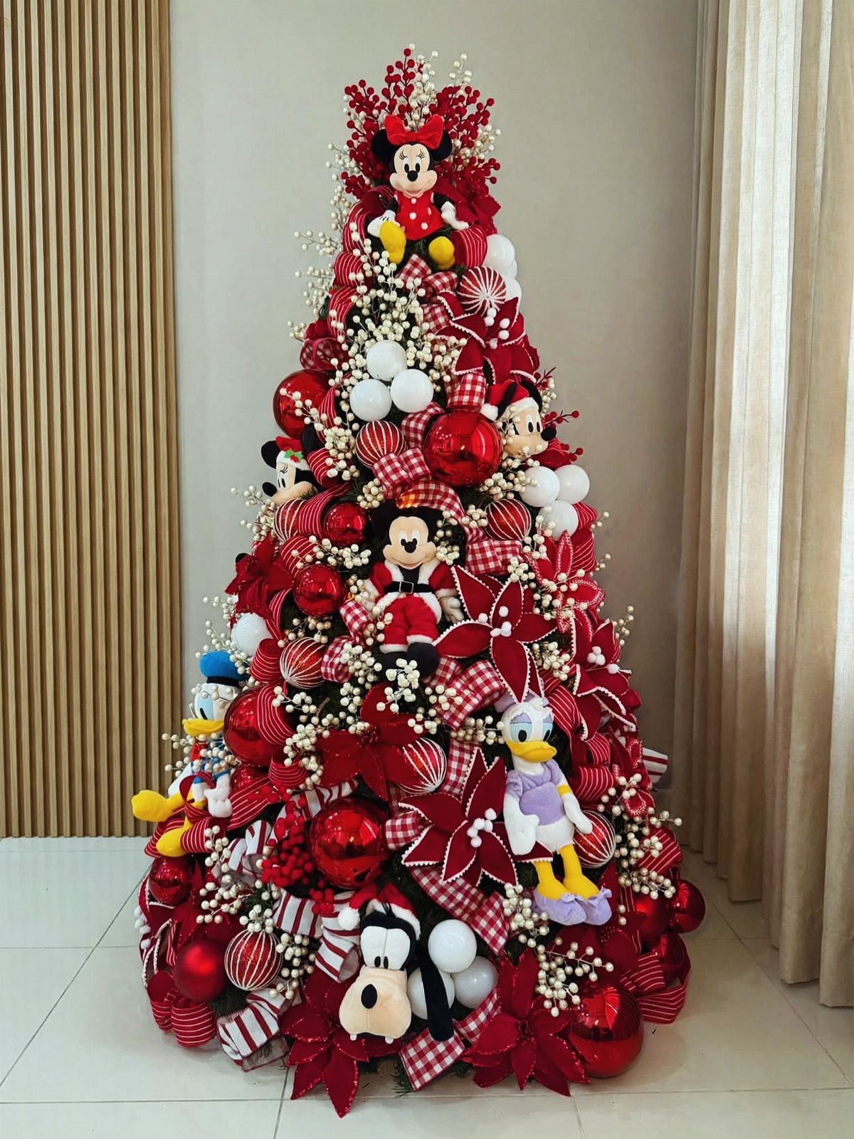 14 Beautiful Christmas Tree Decorations and How to Style Them 4 Christmas tree decorated with red ornaments, plaid ribbons, and Disney character plush toys.