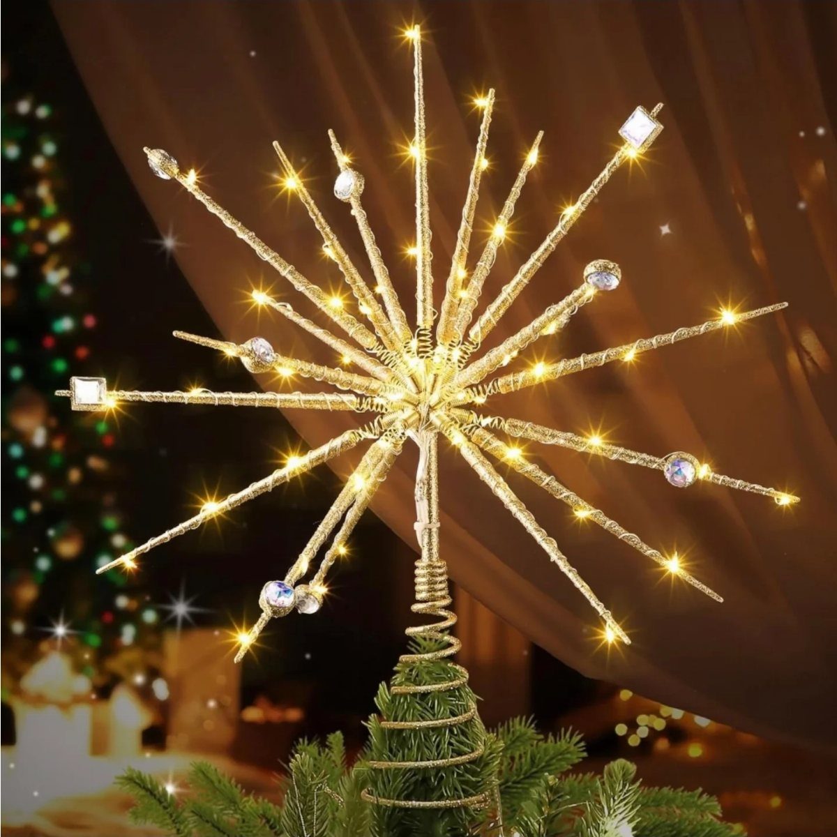 14 Beautiful Christmas Tree Decorations and How to Style Them 3 A glowing gold starburst tree topper with crystal accents on a Christmas tree.