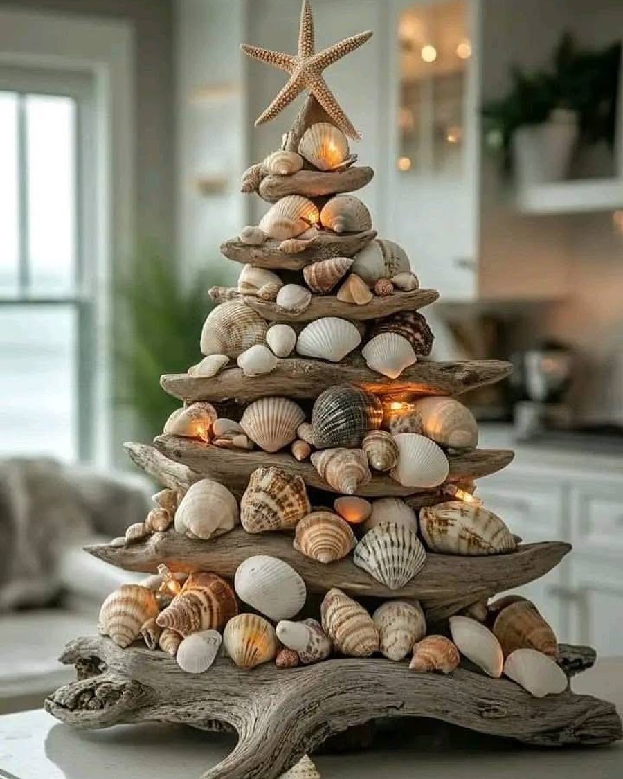 Christmas Decor Aesthetic: 13 Looks to Try This Season 13 A driftwood Christmas tree decorated with seashells and a starfish, glowing with warm lights.