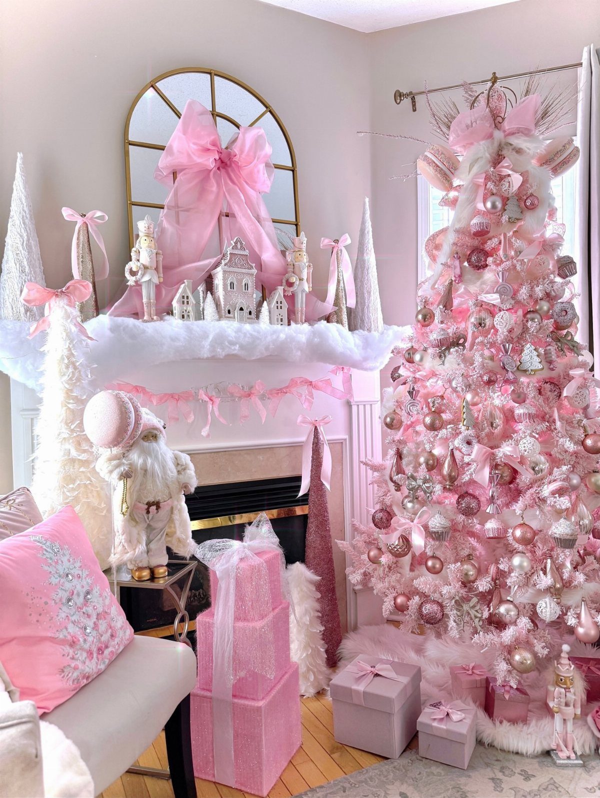 Christmas Decor Aesthetic: 13 Looks to Try This Season 7 Pink Christmas tree decorated with ornaments next to a mantel with pink bows and gift boxes.
