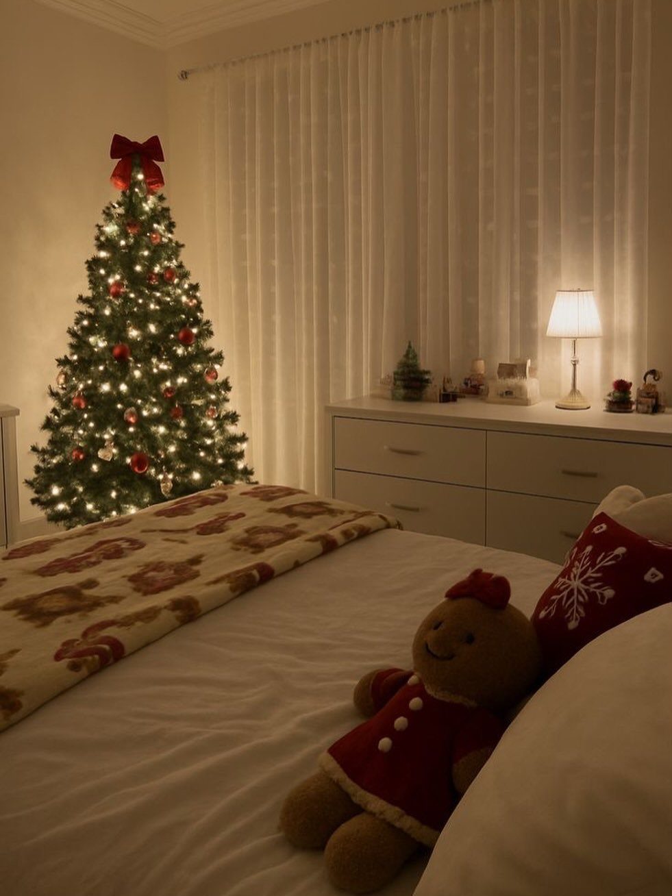Christmas Decoration House: 6 Spaces to Dress, From Porch to Bedroom 4 Lit Christmas tree with a red bow standing in a bedroom next to a white dresser.