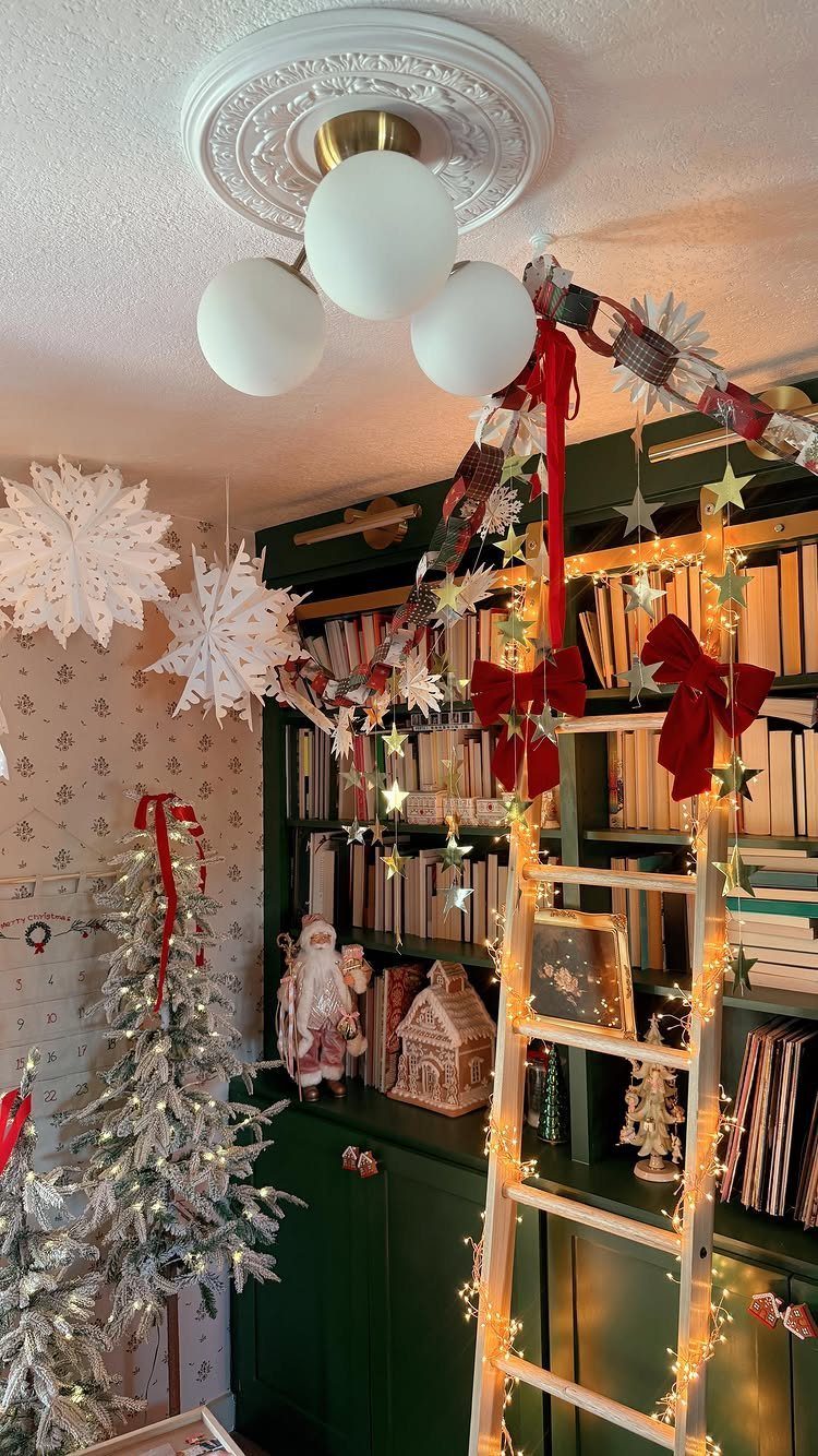 Christmas Decoration House: 6 Spaces to Dress, From Porch to Bedroom 3 Christmas decorations including a flocked tree, star garlands, and red bows on a green bookshelf.