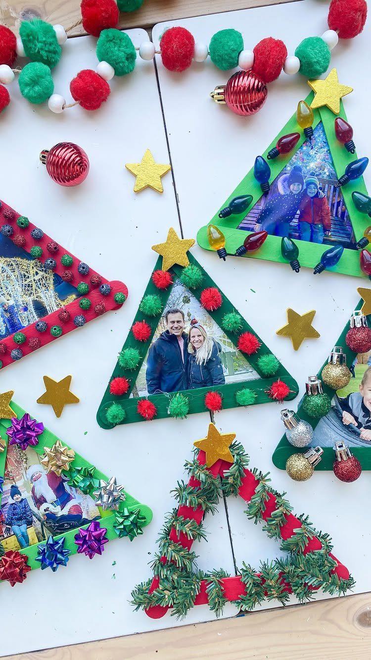 Triangular photo frames decorated with tinsel, pom-poms, and stars on a white background.