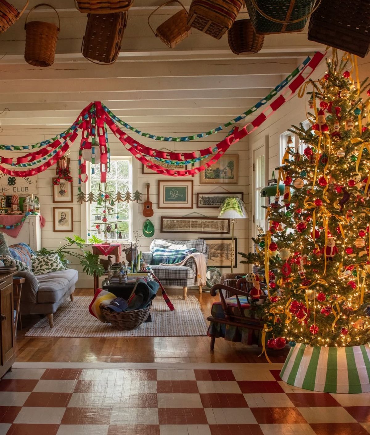 Colorful paper chain garlands draped across a ceiling in a decorated living room.