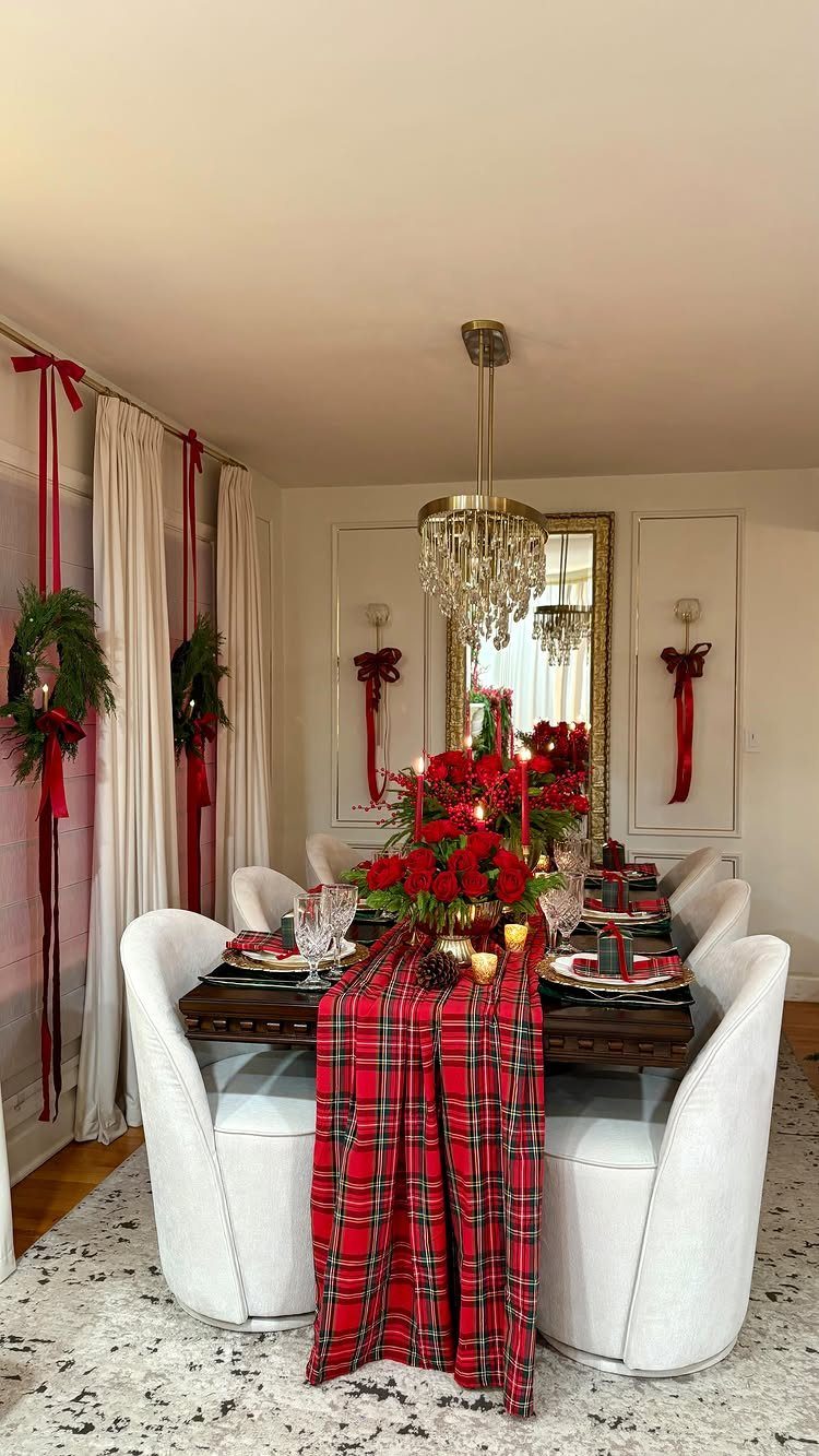 13 Christmas Table Decoration Ideas for Every Style 5 A festive Christmas dining table featuring red roses, greenery, and a red plaid runner.