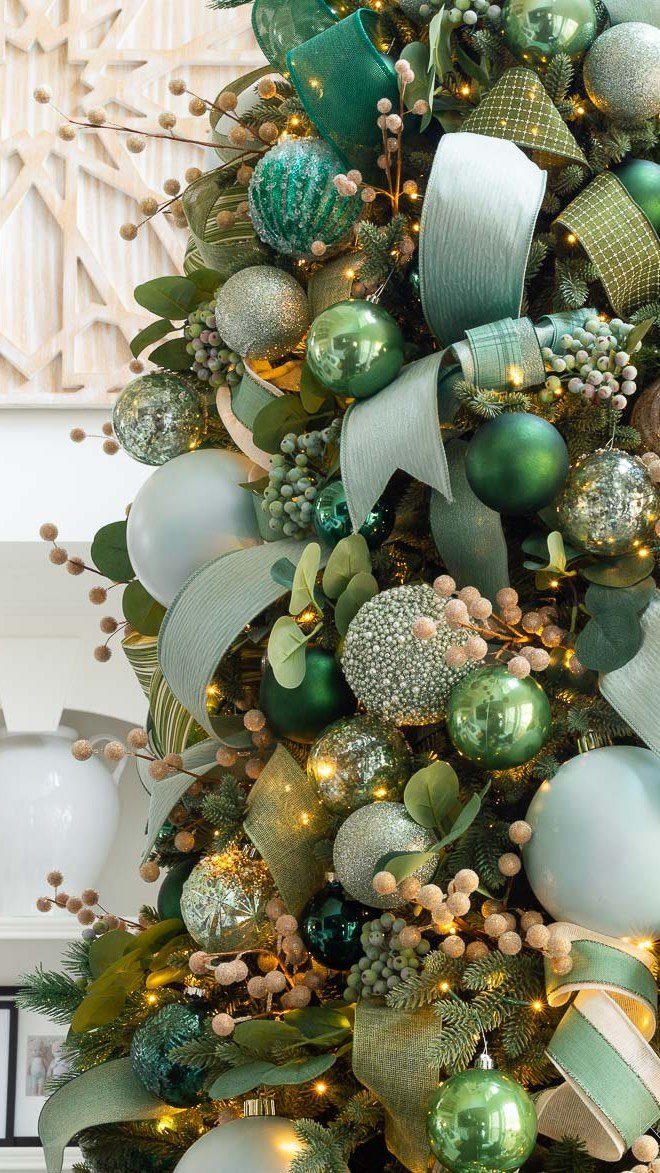 Christmas Tree Ribbon: 18 Styling Ideas That Work 1 Decorated Christmas tree with green ornaments and large, billowy loops of light green ribbon.