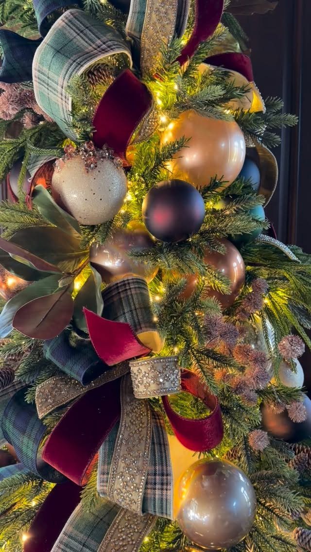 Christmas Tree Ribbon: 18 Styling Ideas That Work 14 Decorated Christmas tree with plaid ribbons, velvet bows, and various colored ornaments under warm lights.