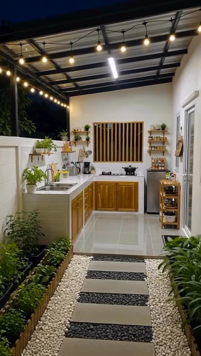 20 Corner Yard Garden Ideas for Any Size Space 15 Outdoor kitchen with wooden cabinets, white countertops, and small potted plants along a pebble walkway.