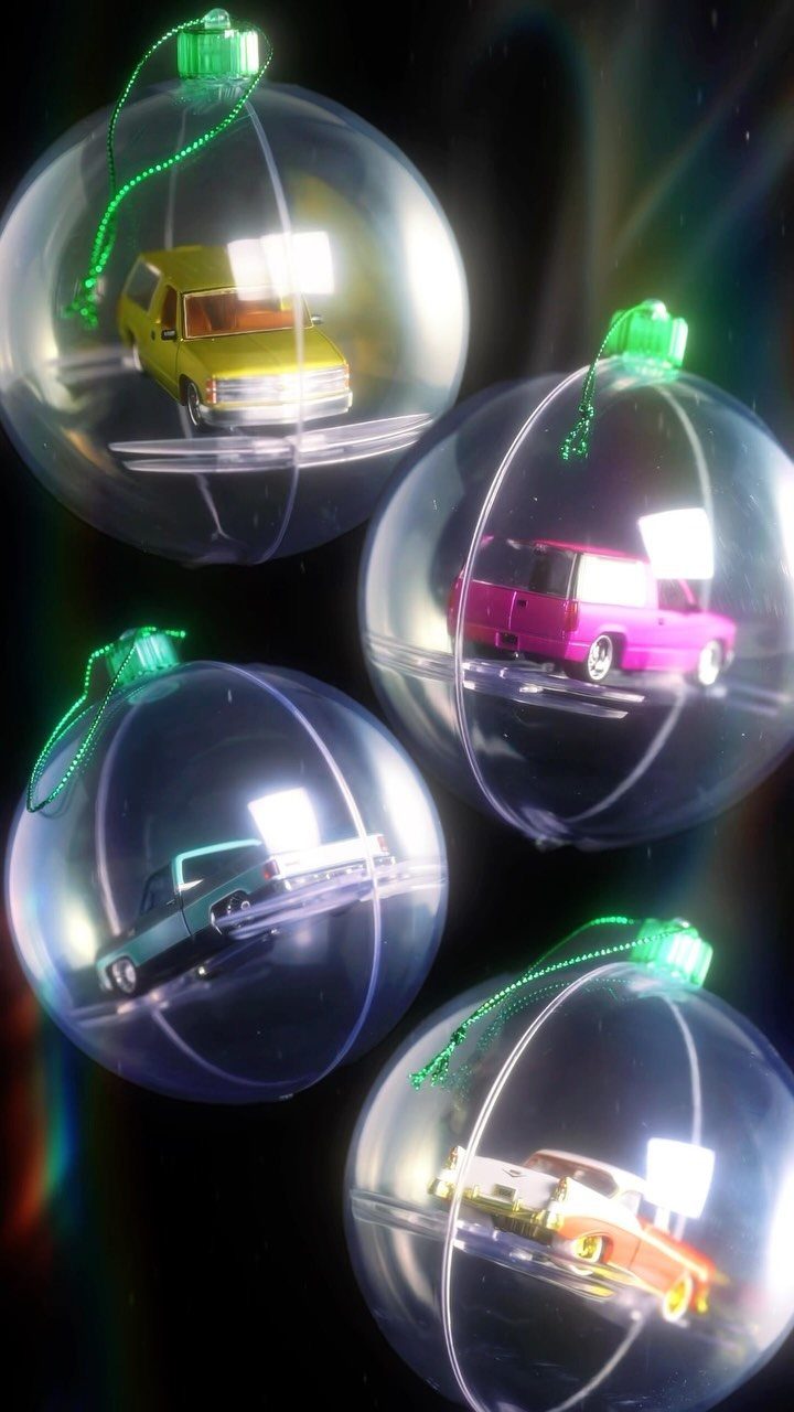 Cricut Christmas Balls: 14 DIY Ornaments for 2026 14 Four clear plastic Christmas ornaments containing miniature toy cars in various colors against a dark background.
