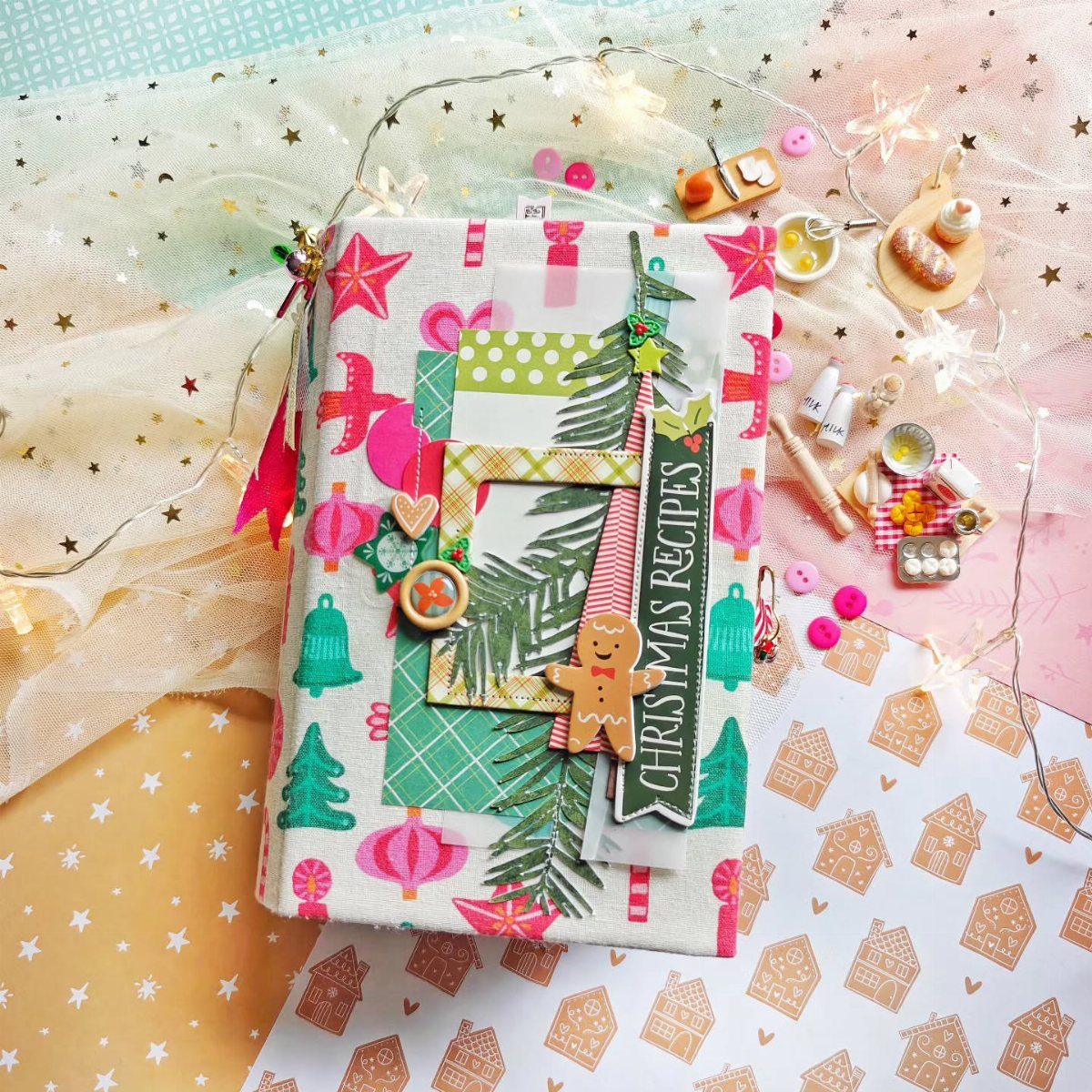 27 DIY Cheap Christmas Gifts for 2026 25 A decorated notebook with Christmas embellishments and the words Christmas Recipes on a festive background.