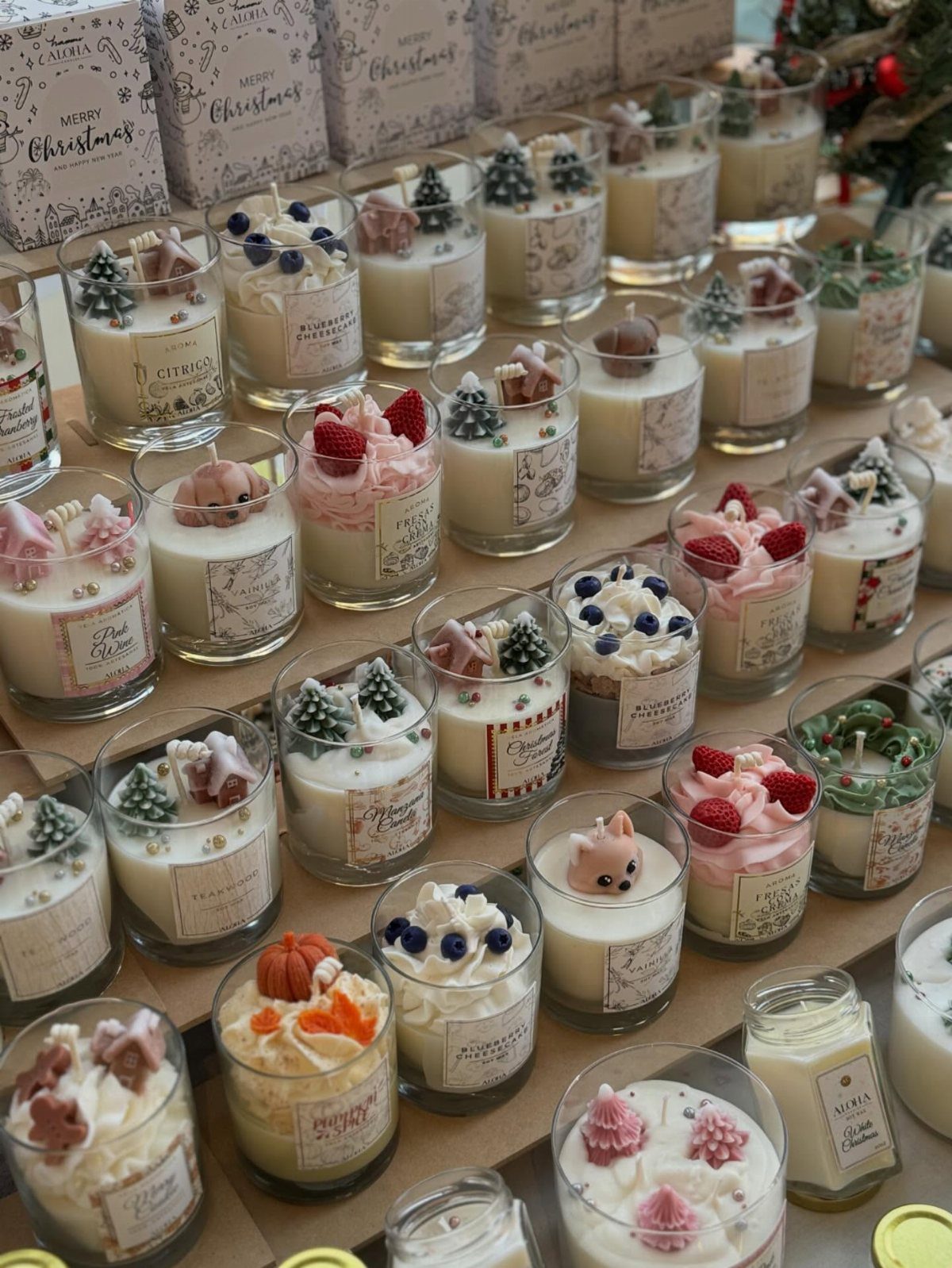 27 DIY Cheap Christmas Gifts for 2026 13 Many decorative dessert-style jar candles arranged closely together on a table.
