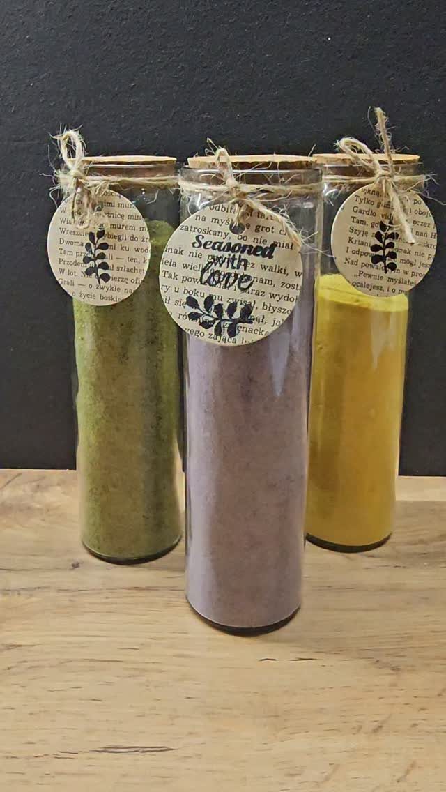 27 DIY Cheap Christmas Gifts for 2026 20 Three glass jars filled with colorful seasoned salt blends on a wooden table.