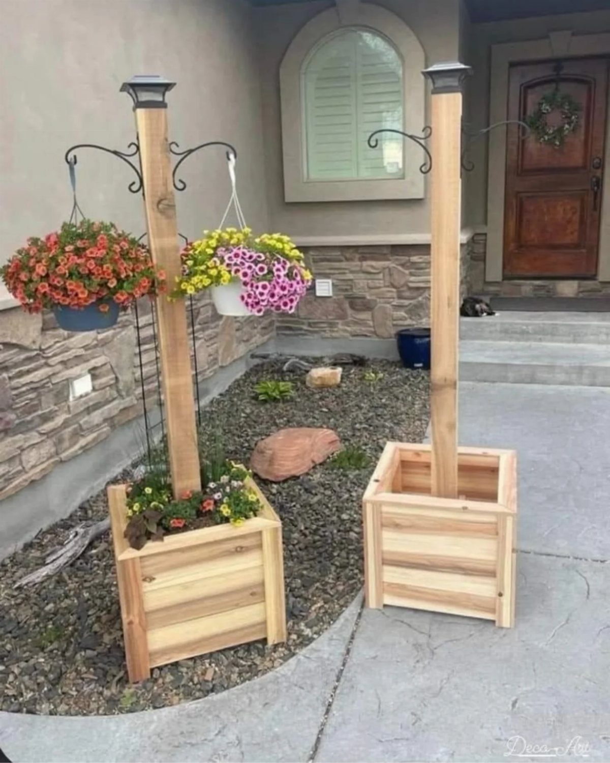9 Easy DIY Planter Ideas for Wood, Upcycled & Clay Projects 3 Two light wood planter boxes with tall posts and hanging flower baskets in a garden.