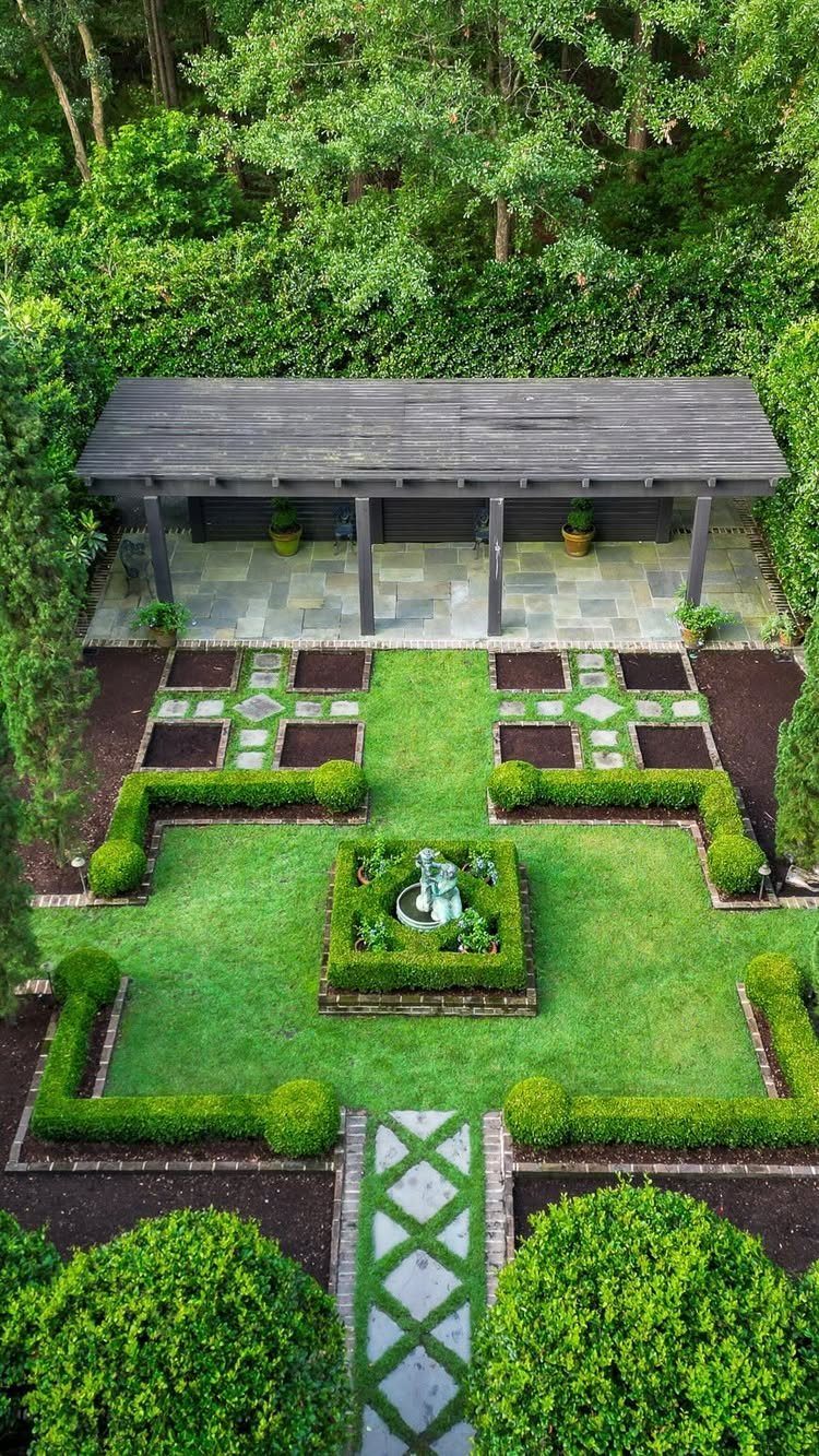 15 Huge Garden Design Ideas for Birds, Light, Night Paths and Still Water 9 Symmetrical formal garden with manicured hedges, geometric stone paths, and a central statue under a wooden pavilion.