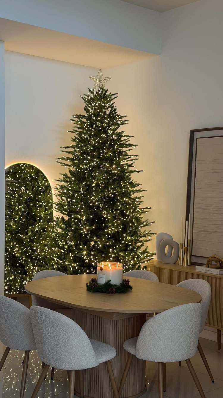 21 Most Beautiful Christmas Trees for Bold and Cozy Looks 21 A tall green Christmas tree glowing with warm white lights and a silver star topper.