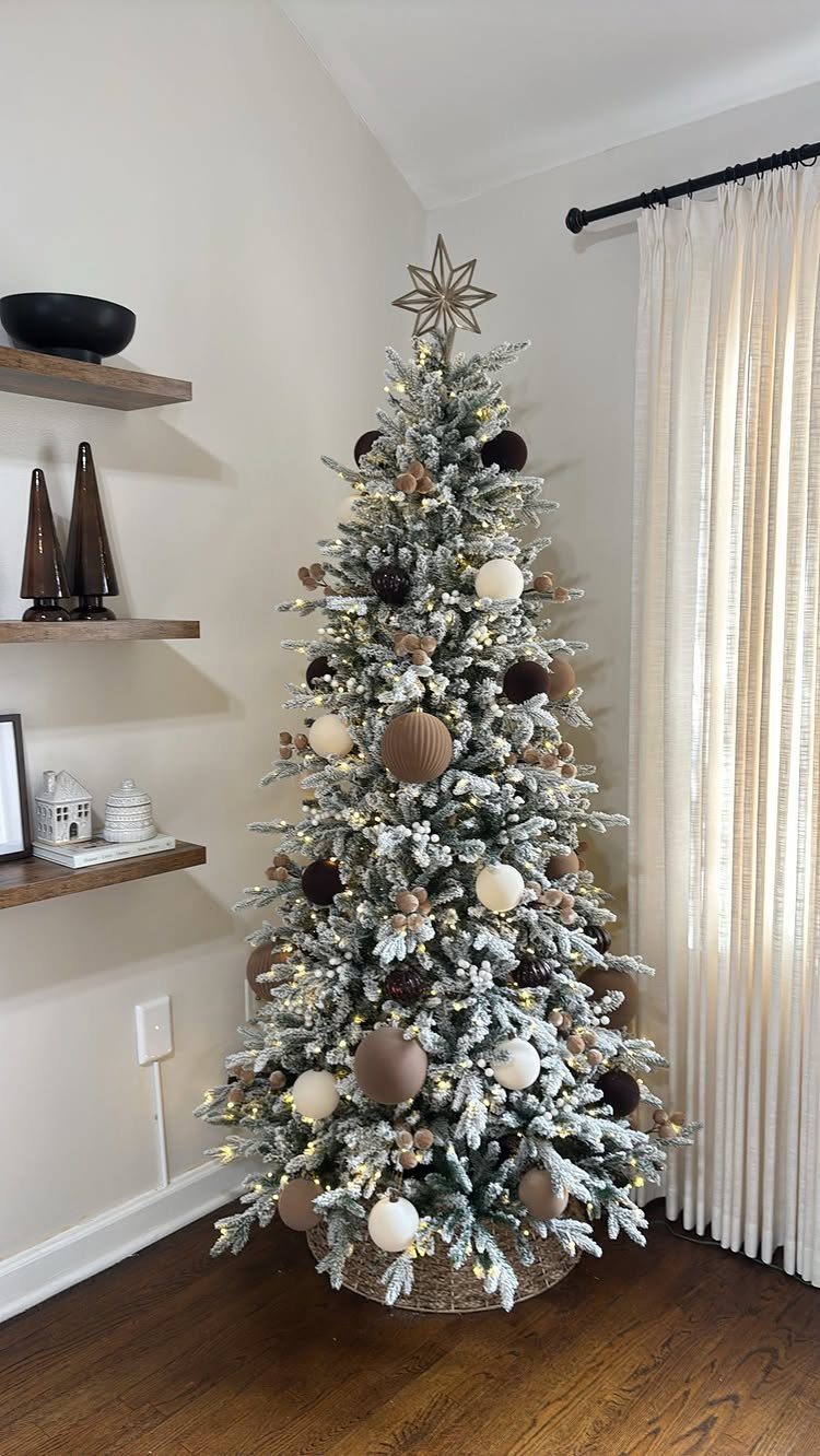 21 Most Beautiful Christmas Trees for Bold and Cozy Looks 17 A flocked Christmas tree decorated with large cream and brown spherical ornaments and a star topper.