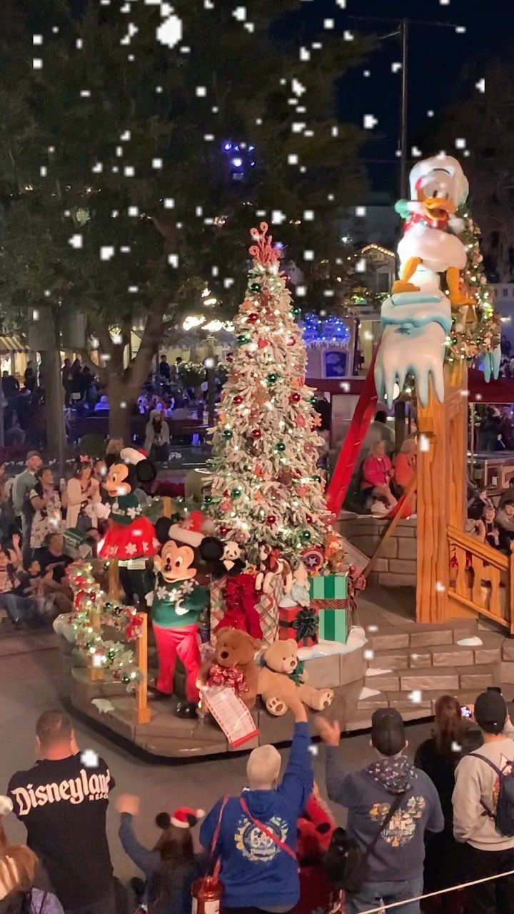 21 Things to Do for Christmas 2026 14 Mickey and Minnie Mouse on a decorated Christmas parade float at night.