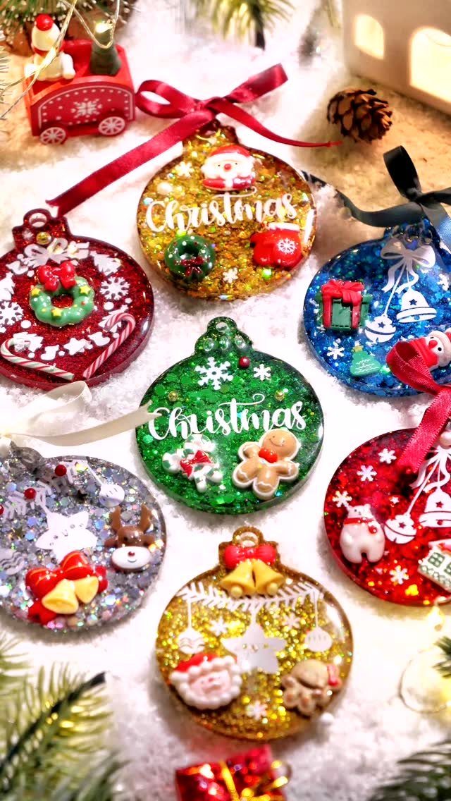 21 Things to Do for Christmas 2026 12 Glittery, colorful Christmas ornaments decorated with festive shapes resting on a snowy surface.