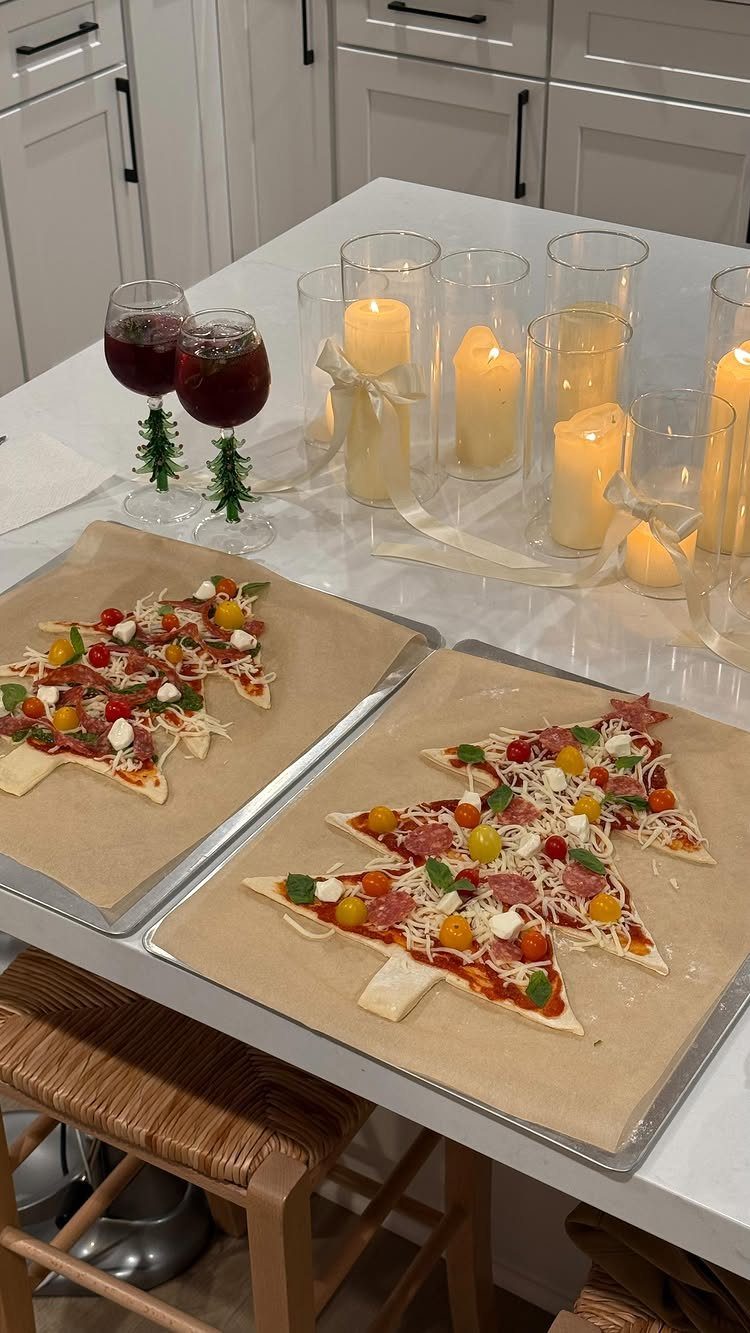 21 Things to Do for Christmas 2026 19 Christmas tree shaped pizzas on baking sheets next to wine and lit candles.